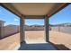 Backyard featuring large open space with a covered patio and block wall fence at 18243 W Daley Ln, Surprise, AZ 85387