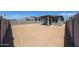 Home's backyard features a covered patio, large open space, and block wall fence at 18243 W Daley Ln, Surprise, AZ 85387