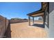 Backyard featuring a covered patio and block wall fence at 18243 W Daley Ln, Surprise, AZ 85387