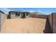 Home's backyard featuring a covered patio, and block wall fence at 18243 W Daley Ln, Surprise, AZ 85387