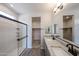Spacious bathroom with granite counters, shower, and a walk-in closet at 18243 W Daley Ln, Surprise, AZ 85387
