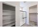 Bathroom features an open linen closet, glass door shower with tiled walls and tile flooring at 18243 W Daley Ln, Surprise, AZ 85387