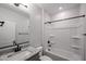 Bathroom with granite vanity top, black faucet and shower with black trim at 18243 W Daley Ln, Surprise, AZ 85387