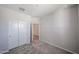 A bright bedroom features neutral paint, carpet, and closet doors at 18243 W Daley Ln, Surprise, AZ 85387