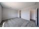 Carpeted bedroom with a doorway leading to another room at 18243 W Daley Ln, Surprise, AZ 85387