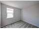 Small bedroom with carpet, base-molding and a window providing natural light at 18243 W Daley Ln, Surprise, AZ 85387