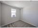 Small bedroom features carpet, base-molding and a window providing natural light at 18243 W Daley Ln, Surprise, AZ 85387