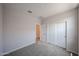Bedroom with sliding-door closet, carpet, and view into the hall at 18243 W Daley Ln, Surprise, AZ 85387