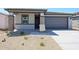 Charming single-story home with a two-car garage, low-maintenance landscaping, and stone accents at 18243 W Daley Ln, Surprise, AZ 85387