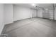 Attached two-car garage with ample space for vehicles and storage, featuring concrete flooring at 18243 W Daley Ln, Surprise, AZ 85387