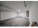 Clean, spacious garage with white walls and concrete floor, ready for parking and storage at 18243 W Daley Ln, Surprise, AZ 85387