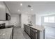 Bright kitchen features granite countertops, stainless steel appliances and gray cabinets at 18243 W Daley Ln, Surprise, AZ 85387