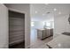Bright kitchen with a full-sized pantry, island with sink, and open-concept to the living area at 18243 W Daley Ln, Surprise, AZ 85387
