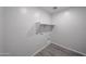 The laundry room includes a shelf for storage and hookups for washer and dryer at 18243 W Daley Ln, Surprise, AZ 85387