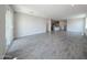 Expansive living area with tile floors, recessed lighting, and sliding glass doors at 18243 W Daley Ln, Surprise, AZ 85387