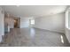 Large living room with ample natural light and tile flooring throughout at 18243 W Daley Ln, Surprise, AZ 85387