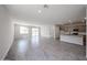 Bright and open floor plan with living room, kitchen, and dining area at 18243 W Daley Ln, Surprise, AZ 85387