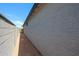 View of home's side yard with stucco wall and block wall at 18243 W Daley Ln, Surprise, AZ 85387