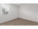 Bedroom showcasing neutral walls and carpet, lit by a window with white blinds at 2008 S 242Nd Ave, Buckeye, AZ 85326