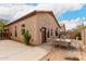 Backyard patio area with outdoor dining, stucco wall, arid landscaping, and inviting ambiance at 2025 N 106Th Dr, Avondale, AZ 85392