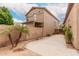 A house's backyard showcasing the desert landscaping with palm trees and a concrete patio at 2025 N 106Th Dr, Avondale, AZ 85392