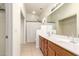 Bright bathroom with wood vanity, modern lighting and neutral walls at 2025 N 106Th Dr, Avondale, AZ 85392