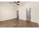 Spacious main bedroom with wood laminate floors, ceiling fan and neutral walls at 2025 N 106Th Dr, Avondale, AZ 85392
