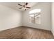 Light-filled bedroom with wood laminate flooring, ceiling fan and vaulted ceiling at 2025 N 106Th Dr, Avondale, AZ 85392