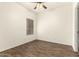 Bedroom features wood-look floors, neutral walls, a ceiling fan, and a window for natural light at 2025 N 106Th Dr, Avondale, AZ 85392