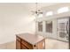 Eat-in kitchen dining area with ceiling fan, tiled floors, and sliding door access to the backyard at 2025 N 106Th Dr, Avondale, AZ 85392
