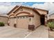 Attractive single-story home with a two-car garage and desert landscaping at 2025 N 106Th Dr, Avondale, AZ 85392