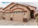 Well-maintained single-story home featuring a two-car garage and desert landscaping at 2025 N 106Th Dr, Avondale, AZ 85392