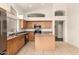 Bright kitchen features wood cabinets, stainless steel appliances, a central island and an open design at 2025 N 106Th Dr, Avondale, AZ 85392