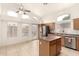 Bright kitchen with tiled floors, stainless steel appliances, and center island at 2025 N 106Th Dr, Avondale, AZ 85392