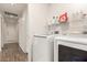 Bright laundry room with modern washer and dryer, shelving, and tile flooring, great for chores at 2025 N 106Th Dr, Avondale, AZ 85392