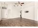 Expansive living room with wood-like flooring, ceiling fan, and a bright, airy feel at 2025 N 106Th Dr, Avondale, AZ 85392