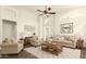 Bright living room with vaulted ceilings, ceiling fan, stylish decor and comfortable seating at 2025 N 106Th Dr, Avondale, AZ 85392