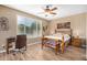 Bright bedroom with a large window and light wood furniture at 219 W Canyon Way, San Tan Valley, AZ 85143