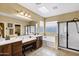 Bathroom with a skylight, a shower with black trim, a bath tub, and double sinks at 2280 E Aloe Pl, Chandler, AZ 85286