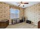 Bedroom with carpeted floors, a ceiling fan, one window, and wallpaper at 2280 E Aloe Pl, Chandler, AZ 85286