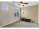 Neutral bedroom featuring a ceiling fan, arched window, and a carpeted floor at 2280 E Aloe Pl, Chandler, AZ 85286