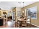 Eat-in kitchen features a wooden dining set and sliding glass doors leading to the backyard waterfall at 2280 E Aloe Pl, Chandler, AZ 85286