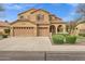 Expansive two-story home featuring a three-car garage, desert landscaping, and a beautiful neutral color palette at 2280 E Aloe Pl, Chandler, AZ 85286