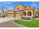 Charming two-story home featuring a three-car garage, tile roof, and well-manicured front yard at 2280 E Aloe Pl, Chandler, AZ 85286