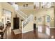 Grand foyer with a staircase, chandelier, and abundant natural light flooding in at 2280 E Aloe Pl, Chandler, AZ 85286
