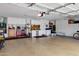 Spacious and organized garage featuring ample storage cabinets, and an expansive work area with a clean epoxy floor at 2280 E Aloe Pl, Chandler, AZ 85286