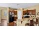 A kitchen with a breakfast bar, dark wood cabinets, granite countertops, and stainless steel appliances at 2280 E Aloe Pl, Chandler, AZ 85286