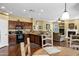 Open kitchen and living area, featuring dark wood cabinets, granite countertops, and stainless steel appliances at 2280 E Aloe Pl, Chandler, AZ 85286