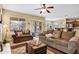 Inviting living room features cozy sofas, ceiling fan, and views of the outdoor space at 2280 E Aloe Pl, Chandler, AZ 85286