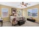 Cozy main bedroom featuring a ceiling fan, plush carpet, and bright windows at 2280 E Aloe Pl, Chandler, AZ 85286